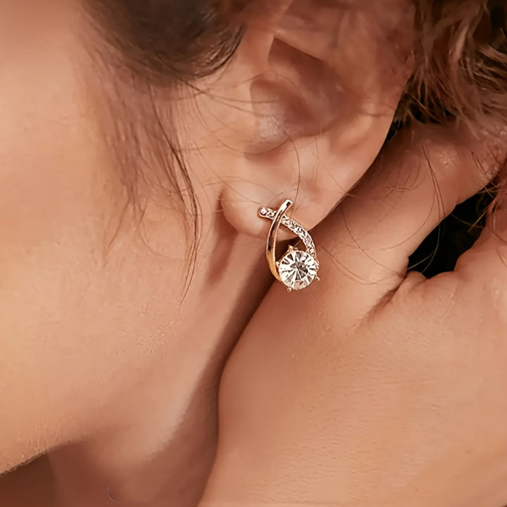 Boucles d'oreilles à clou avec croix dorée et zircons
